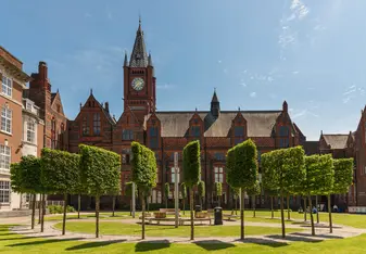 University of Liverpool campus surrounded by green trees and our historic red brick buildings