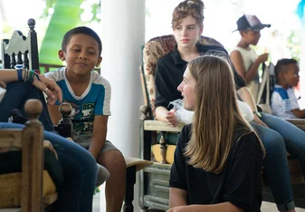 Volunteers chatting with local students