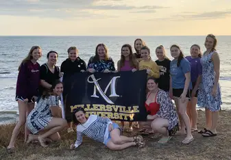 MU students at a volcanic sand beach