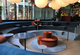 Carpeted amphitheater in an office space.