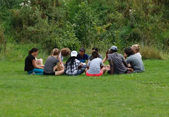 Participants in a circle outdoors 