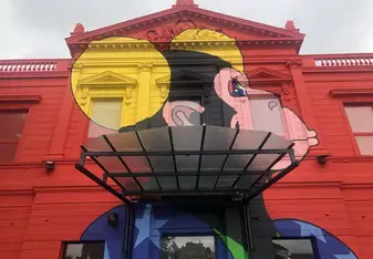 Building face of the 'Centro Cultural'--mural of a colorful monkey