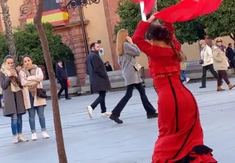 Flamenco dancing is well known in Seville. There are street performers that perform as you are walking down the street. This image is of a bailaora near a fountain in Seville and she is performing her own flamenco style. 