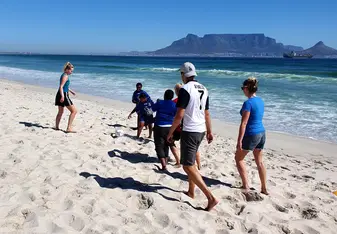 playing soccer on the beach