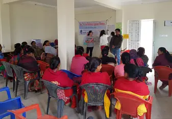 Volunteers teaching about domestic violence to a group of local women at a women's center