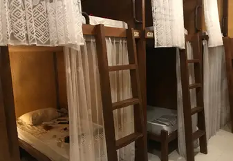 These were the nicer bedrooms. A small cabin with your bed, a small cabinet for storage inside and a lamp, with a mosquito net. Each room can sleep 6-10.
