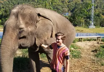 Petting an elephant during one of Global U's Adventure Weekend