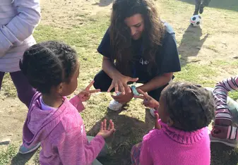 I was teaching these little girls how to play rock paper scissors 