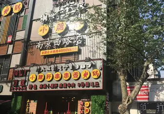 A colorful front of a restaurant that has neon Chinese characters all over it