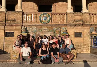 Students pose in front of the crest of Spain's provinces after taking a walking-guided tour. 