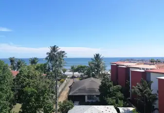 sunny blue skies, overlooking a beach