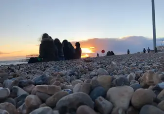 Nothing goes over a relaxing sunset at the seafront with friends