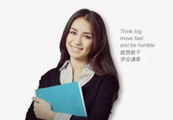 woman holding notebook and smiling in front of a white background