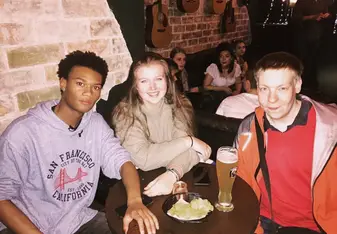 Three people sitting around a table