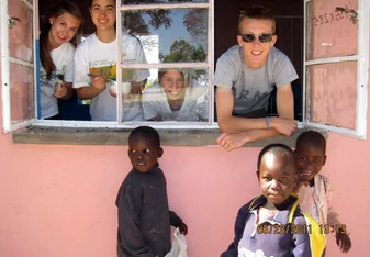 Volunteers look out from classroom