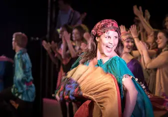 a young woman dancing in colorful costume