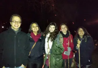 a group of students, bundled up, posing together 