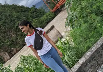 girl standing outdoors, looking into the distance