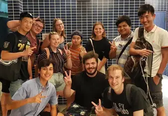 students posing, giving peace signs