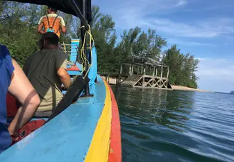 a view over the side of a boat onto a remote island