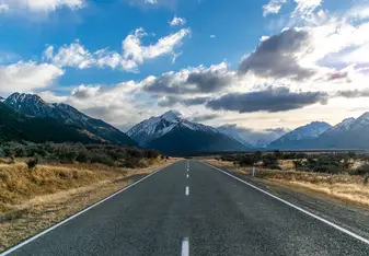 an open road under a clear blue sky