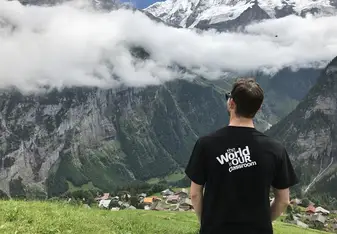 a young man looking out over a misty landscape 