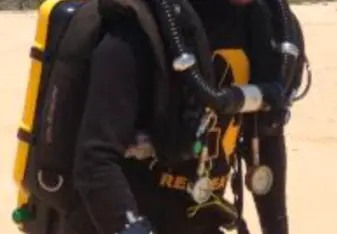 Jon in a wetsuit and dive pack