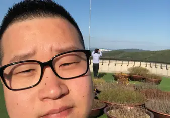 Andy taking a selfie in front of the Korean flag