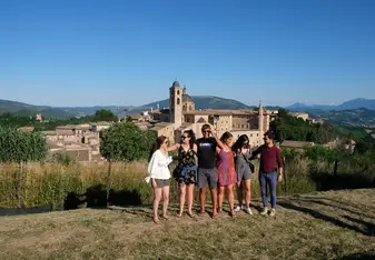 A group of participants posing in front of an Italian vista