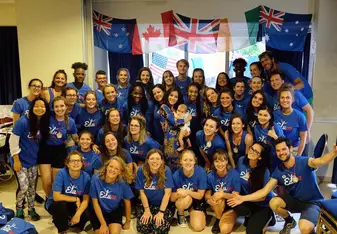 A group of participants posing in matching t-shirts