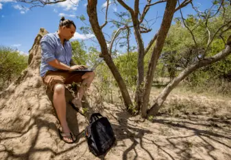 Stuart sitting in the wilderness