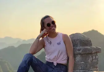 Kelly posing at an overlook of a valley