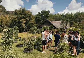 A group of people in a lush, sunny garden