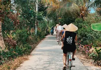 A group of people riding bikes along a road