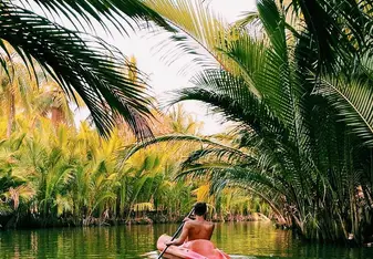 Sam kayaking down a jungle river