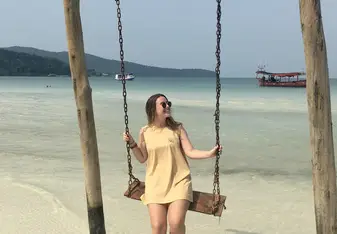 Anna on a swing in the ocean