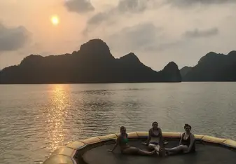 Anna and friends posing on a trampoline in a body of water