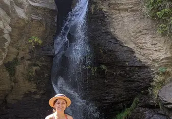 Kasia posing in front of a waterfall