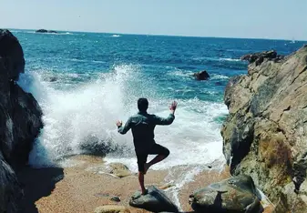 Carlos posing in front of a crashing wave
