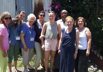 Chemida poses with a group of volunteers