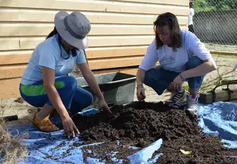 Samantha and another woman do manual labor