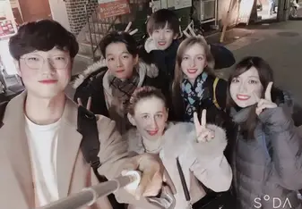 Nanami poses with a group of interns