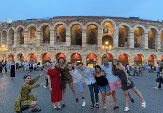 Alexa poses with friends in front of the Colosseum 