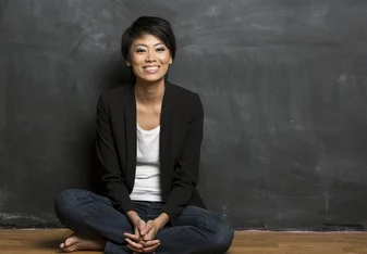 Teacher in Hong Kong in front of a blackboard