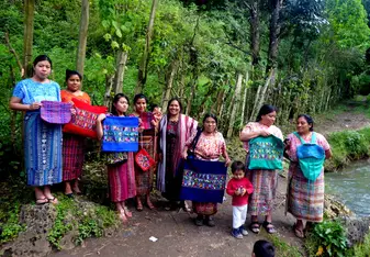 Weavers showing off their hand-woven pillows