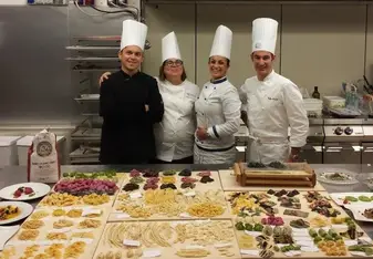 Four chefs in a kitchen.