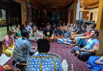 Students gathered around for a community activity in Fiji