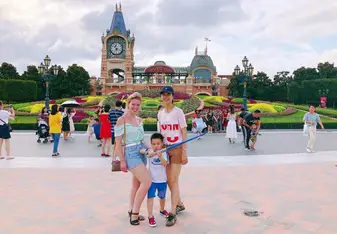 Two women and a child posing outside.