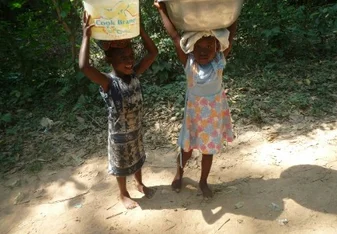 children carrying bucket