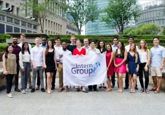 interns with The Intern Group flag